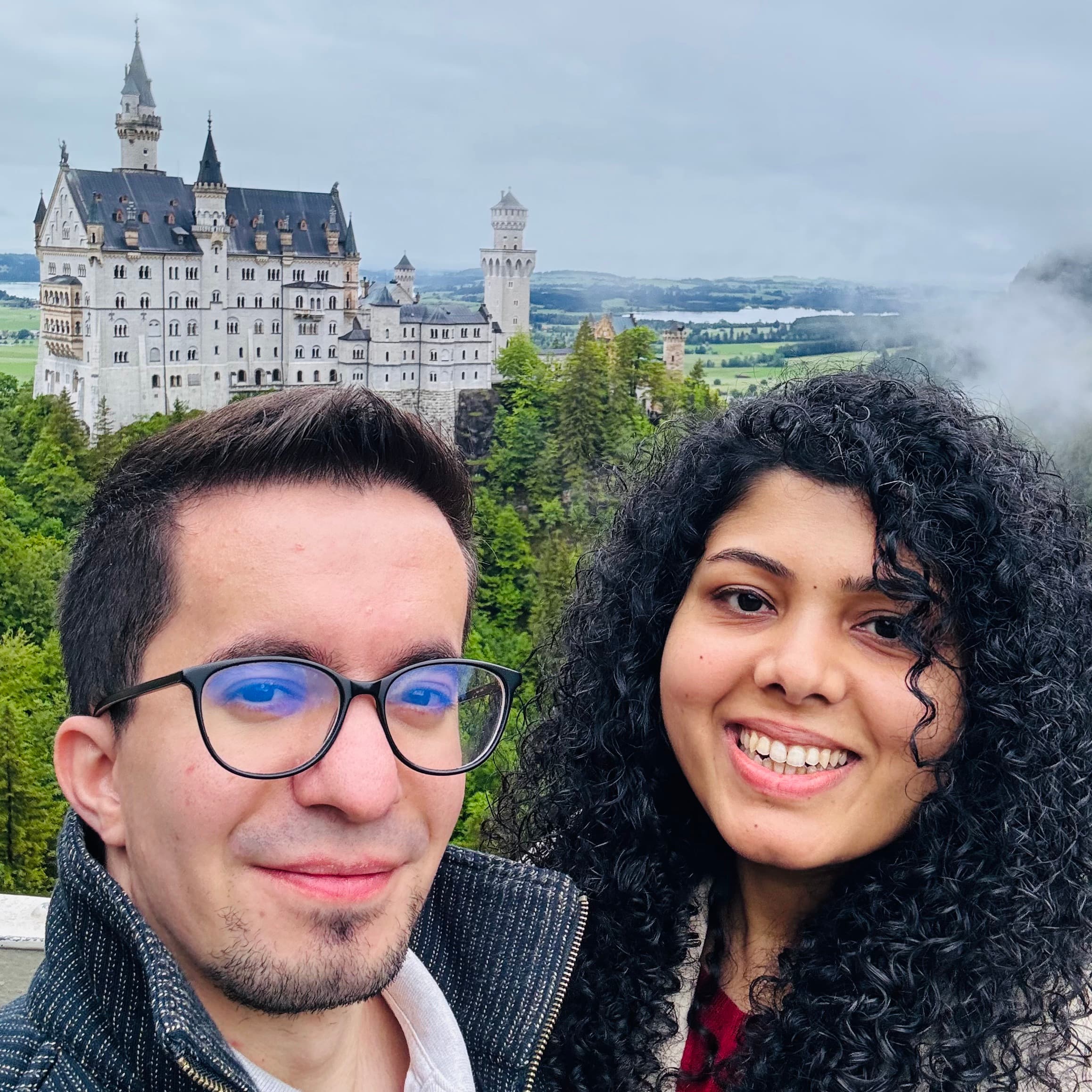 Gayatri and Oleg taking a selfie in front of Neuschwanstein Castle